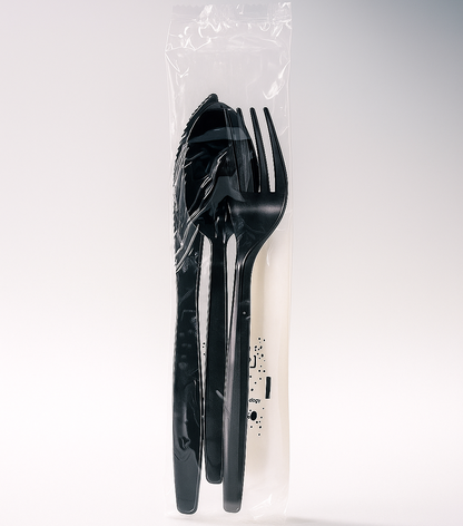 Black plastic cutlery set in a clear plastic bag on a white background